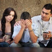 Sympathetic Latino parents with depressed male teenager